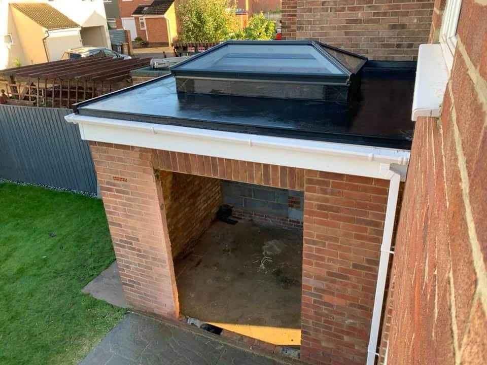 New flat GRP fibreglass roof with roof lantern on a brick home extension in Essex